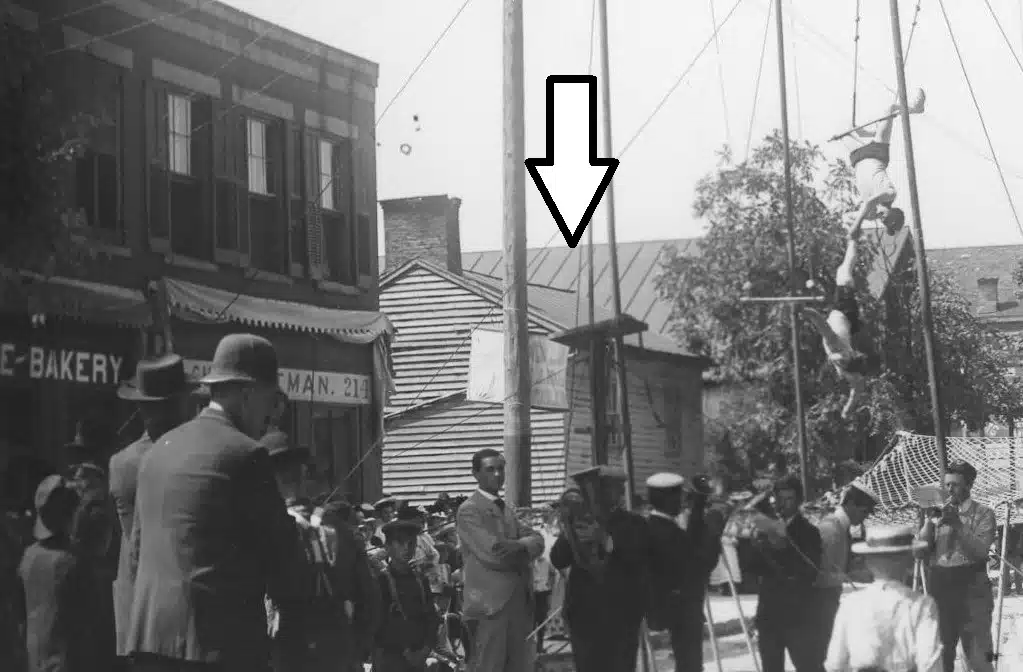 Photo with caption: The arrow points to the land office as seen in the background of this 1905 street fair photographed by Ben Winans. From the FCPLD collection. Indiana Historical Society copyright holder.